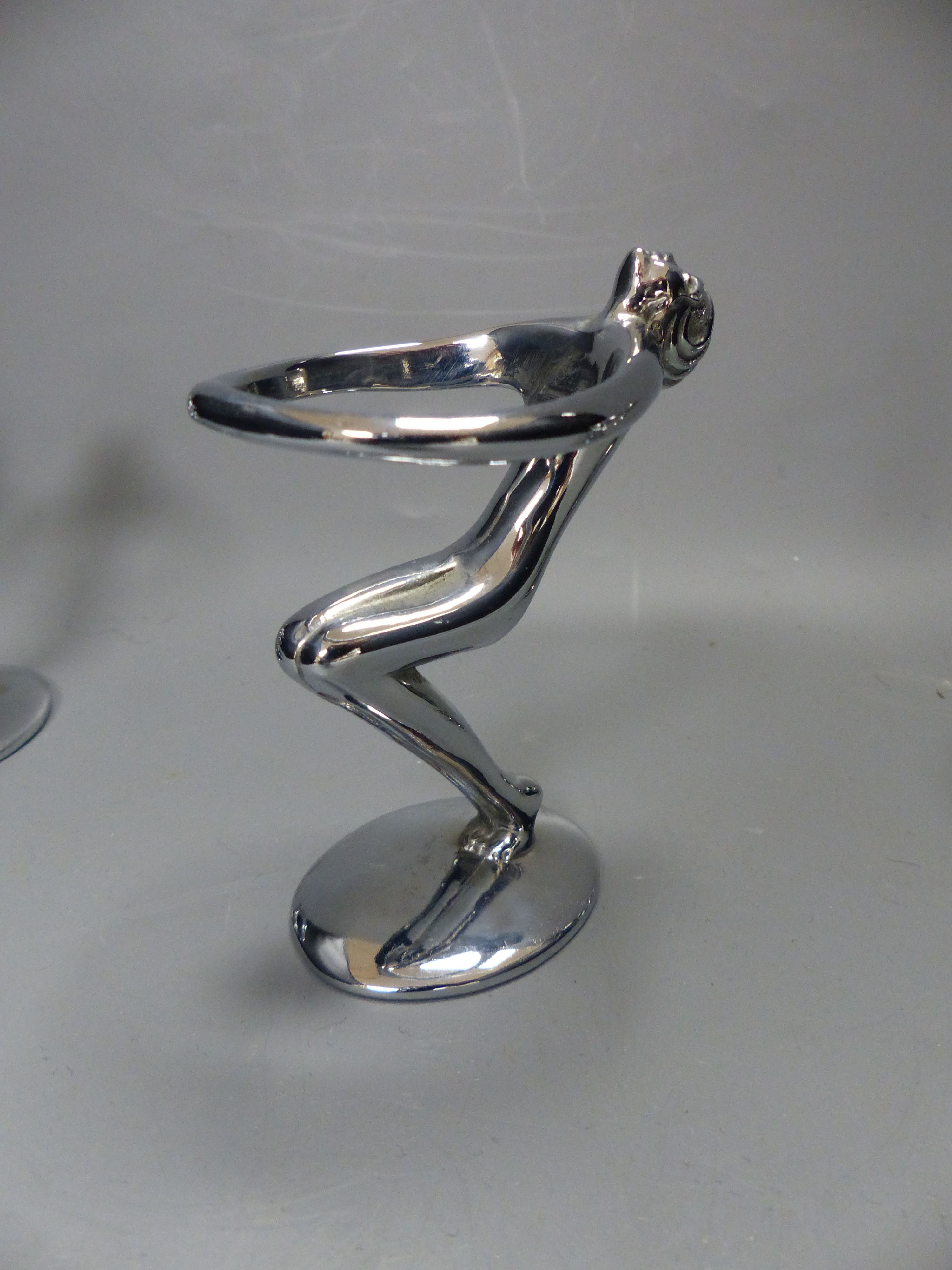 A post war chrome set of six figural egg holders, height 9cm